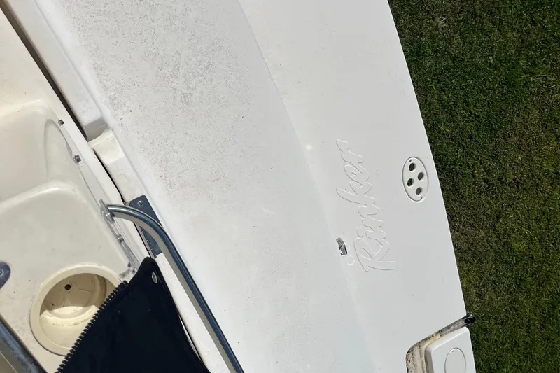 Slide: The Image of 2000 Rinker 340 Fiesta Vee boat deck with logo and railing. - 8