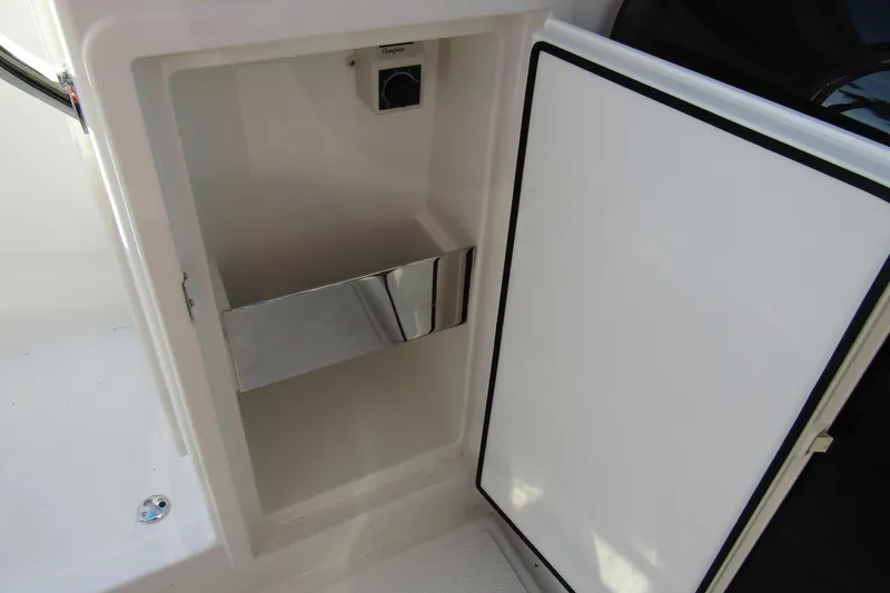 Slide: The Image of Open storage compartment on 2025 Nimbus Tender 9 boat, featuring a sleek interior design. - 27