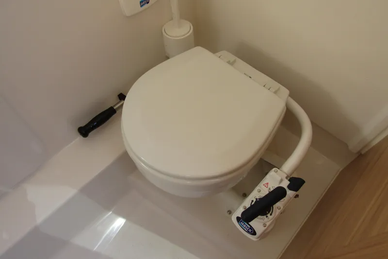 Slide: The Image of Boat toilet in Nimbus Tender 9, 2025 model, featuring manual flush handle. - 23