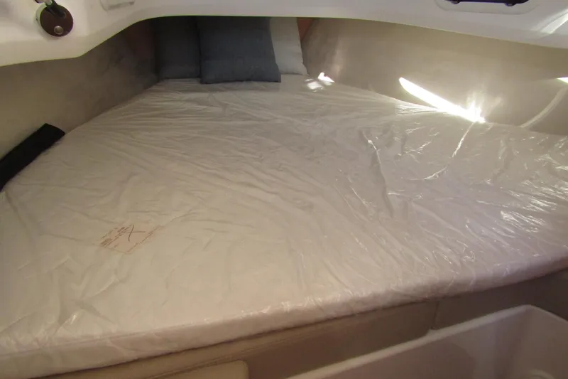 Slide: The Image of Interior cabin of 2025 Nimbus Tender 9 with a neatly covered bed. - 25