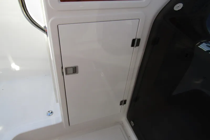 Slide: The Image of Storage compartment on a 2025 Nimbus Tender 9 boat, featuring a sleek white door. - 26