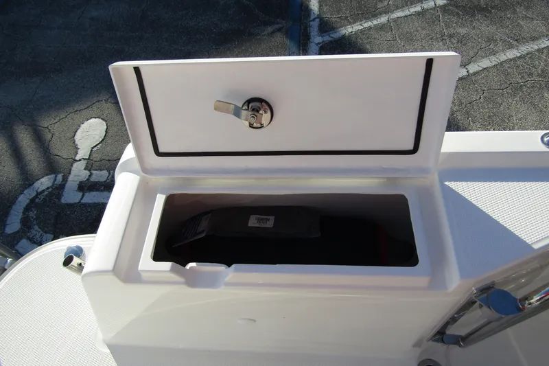 Slide: The Image of Open storage compartment on 2025 Nimbus Tender 9 boat, featuring secure latch. - 36