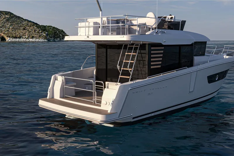 Slide: The Image of 2026 Beneteau Swift Trawler 37 FLY on serene ocean waters near rocky coastline. - 8