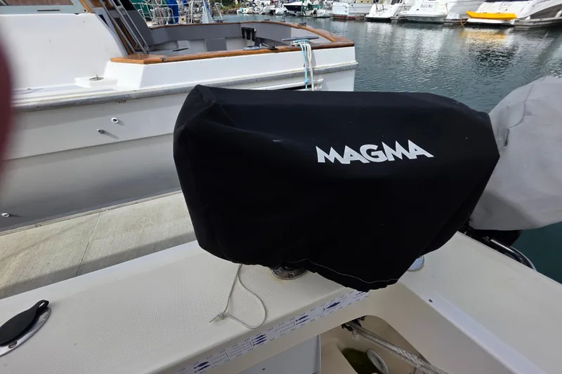 Slide: The Image of Covered Magma grill on 2005 Mainship 34 Pilot Sedan Rum Runner II boat deck. - 10