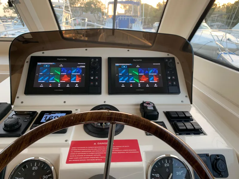 Slide: The Image of Helm of 2005 Mainship 34 Pilot Sedan Rum Runner II with dual navigation screens. - 17