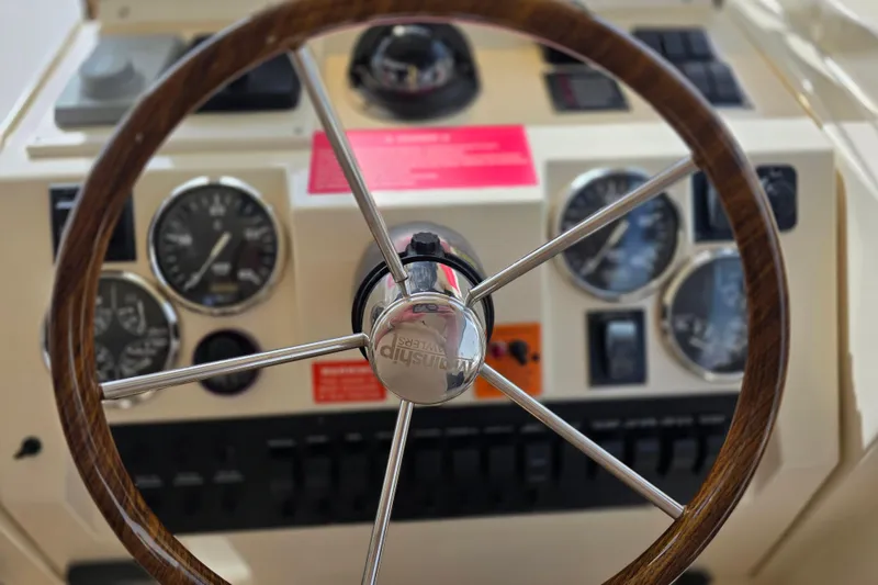 Slide: The Image of Steering wheel and dashboard of 2005 Mainship 34 Pilot Sedan Rum Runner II boat. - 19