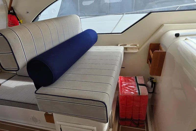 Slide: The Image of 2005 Mainship 34 Pilot Sedan Rum Runner II interior with striped seating and safety equipment. - 20