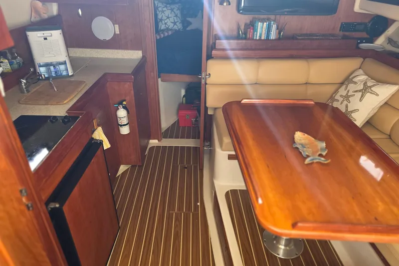Slide: The Image of Interior of 2005 Mainship 34 Pilot Sedan Rum Runner II with kitchenette and seating area. - 24