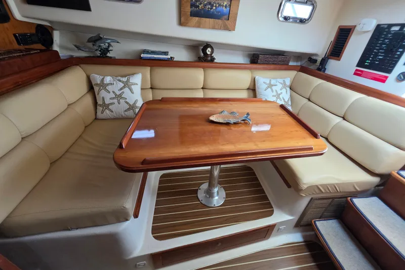 Slide: The Image of Interior of 2005 Mainship 34 Pilot Sedan Rum Runner II with cozy seating and wooden table. - 27