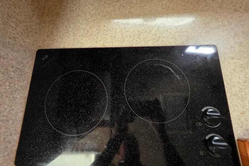 Slide: The Image of Ceramic cooktop in 2005 Mainship 34 Pilot Sedan Rum Runner II kitchen. - 33