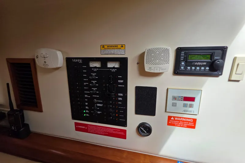 Slide: The Image of Control panel of 2005 Mainship 34 Pilot Sedan Rum Runner II with various gauges and warnings. - 34