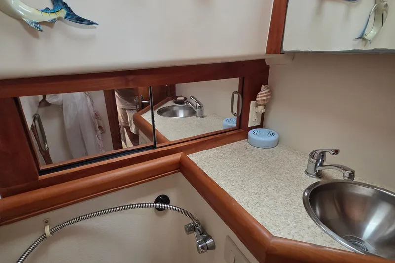 Slide: The Image of 2005 Mainship 34 Pilot Sedan Rum Runner II bathroom with sink, mirror, and countertop. - 40