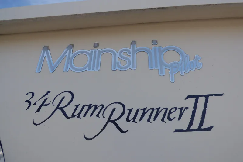 Slide: The Image of Mainship 34 Pilot Sedan Rum Runner II, 2005 model, boat nameplate detail. - 49