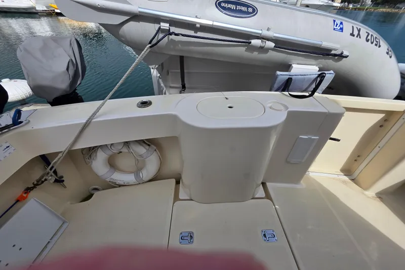 Slide: The Image of 2005 Mainship 34 Pilot Sedan Rum Runner II boat deck with life preserver and dinghy. - 8