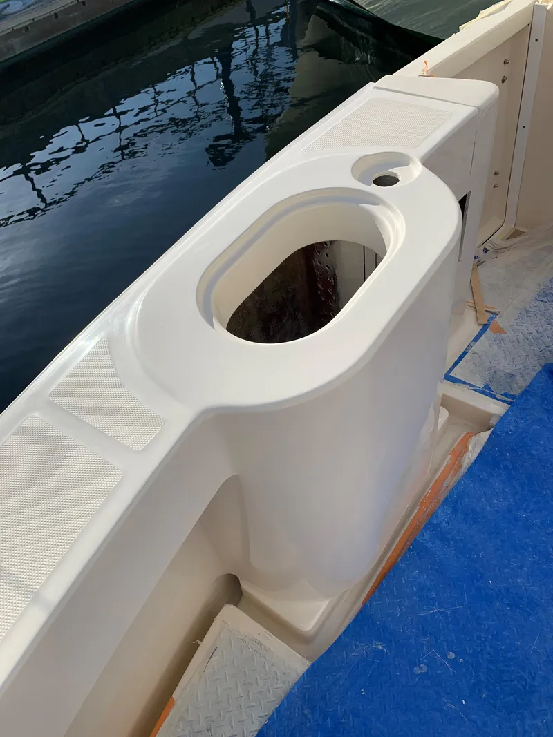 Slide: The Image of 2005 Mainship 34 Pilot Sedan Rum Runner II boat deck detail by the water. - 9