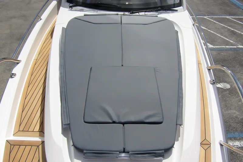 Slide: The Image of Nimbus Weekender 9 (2025) boat with cushioned deck and wooden accents. - 14