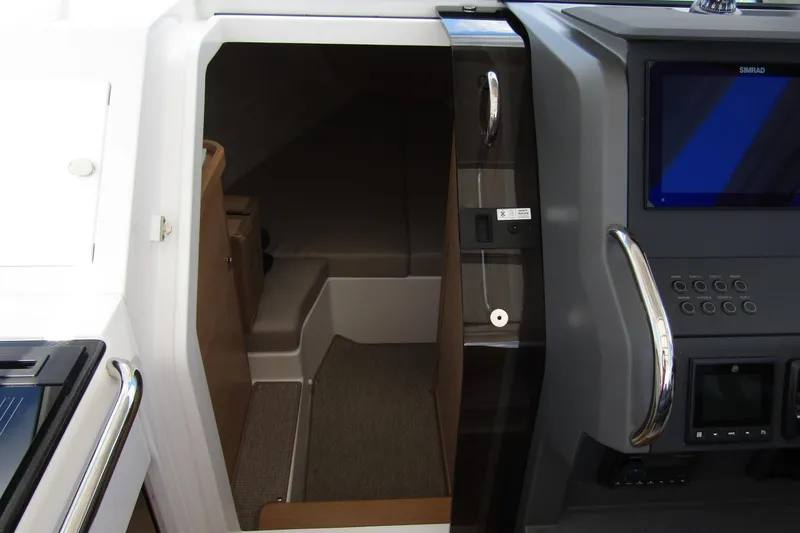 Slide: The Image of Interior cabin view of 2025 Nimbus Weekender 9 boat with modern dashboard. - 26