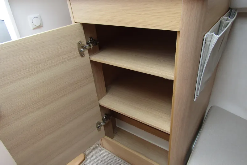 Slide: The Image of Open wooden cabinet with shelves inside a 2025 Nimbus Weekender 9. - 29