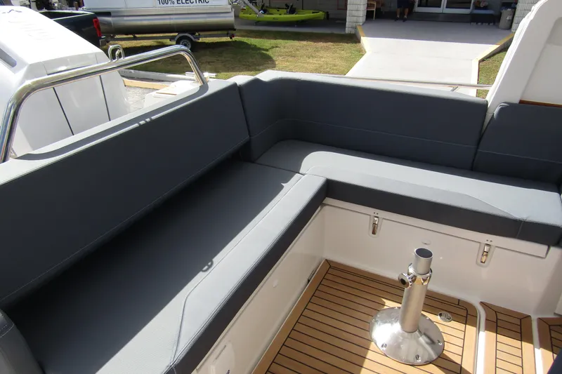Slide: The Image of Nimbus Weekender 9 (2025) boat interior with gray seating and wooden flooring. - 41