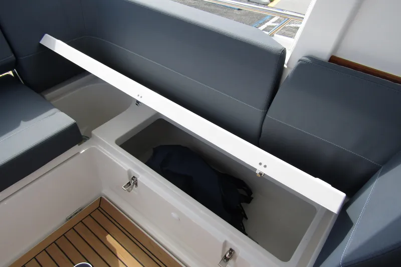 Slide: The Image of Open storage compartment on Nimbus Weekender 9 boat, 2025 model, with cushioned seating. - 45