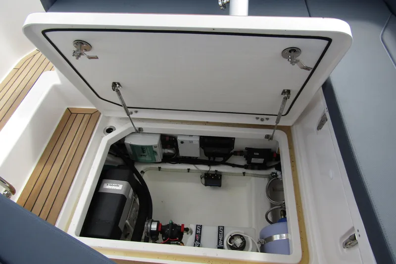 Slide: The Image of Open engine compartment of 2025 Nimbus Weekender 9 boat, showcasing mechanical components. - 46