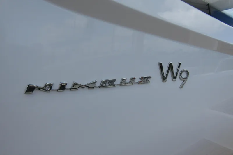 Slide: The Image of 2025 Nimbus Weekender 9 boat logo on sleek white surface. - 10