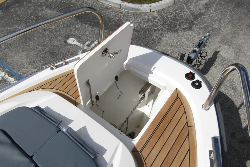 Slide: The Image of Open anchor compartment on 2025 Nimbus Weekender 9 boat with teak decking. - 13