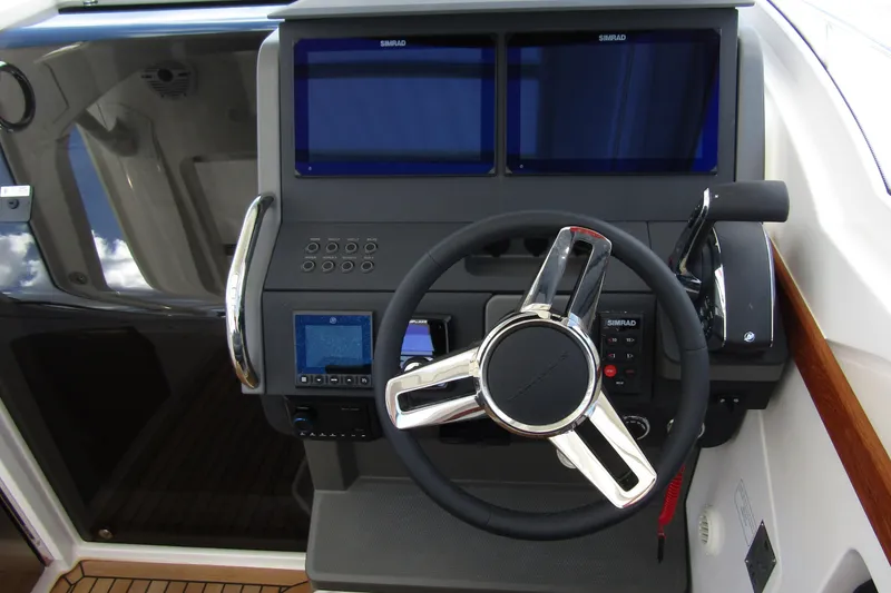 Slide: The Image of Steering console of 2025 Nimbus Weekender 9 boat with dual Simrad displays. - 16