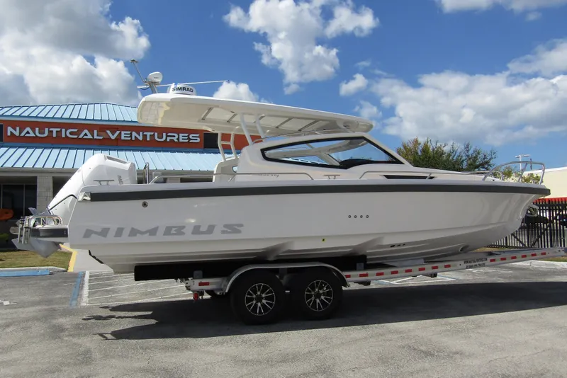 Slide: The Image of 2025 Nimbus Weekender 9 boat on trailer at Nautical Ventures dealership. - 4
