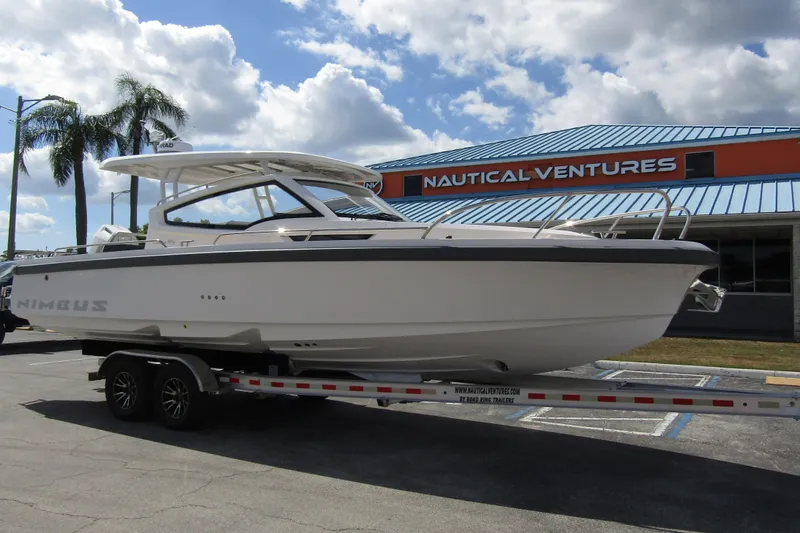 Slide: The Image of 2025 Nimbus Weekender 9 boat on trailer at Nautical Ventures dealership. - 6