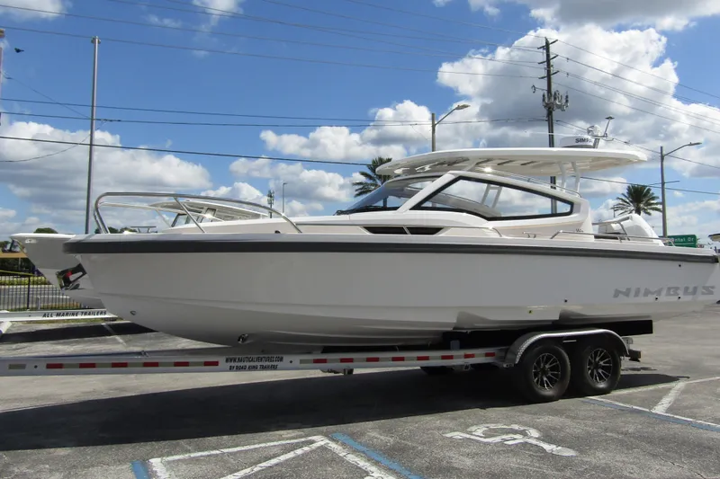 Slide: The Image of 2025 Nimbus Weekender 9 boat on trailer under blue sky. - 9