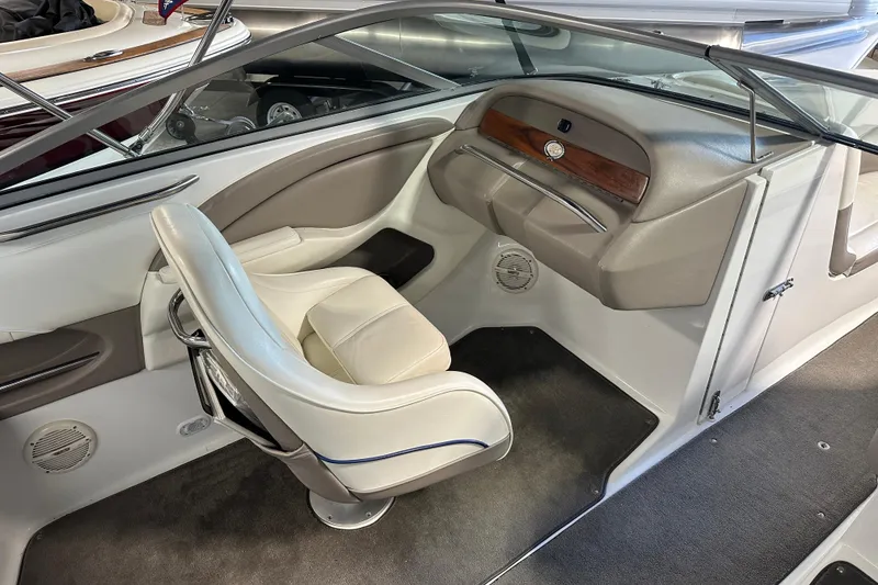 Slide: The Image of Interior of a 2006 Cobalt 220 boat featuring a sleek, modern helm and seating. - 12