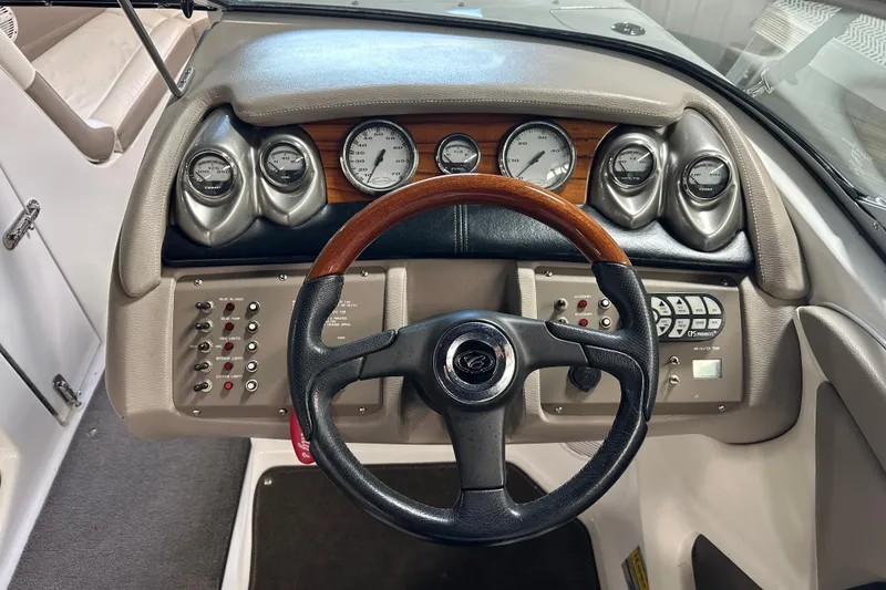 Slide: The Image of Steering wheel and dashboard of 2006 Cobalt 220 boat with gauges and controls. - 16