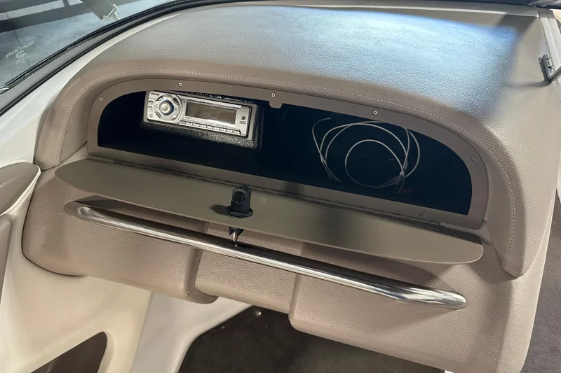 Slide: The Image of Dashboard of a 2006 Cobalt 220 boat with stereo system and storage compartment. - 17