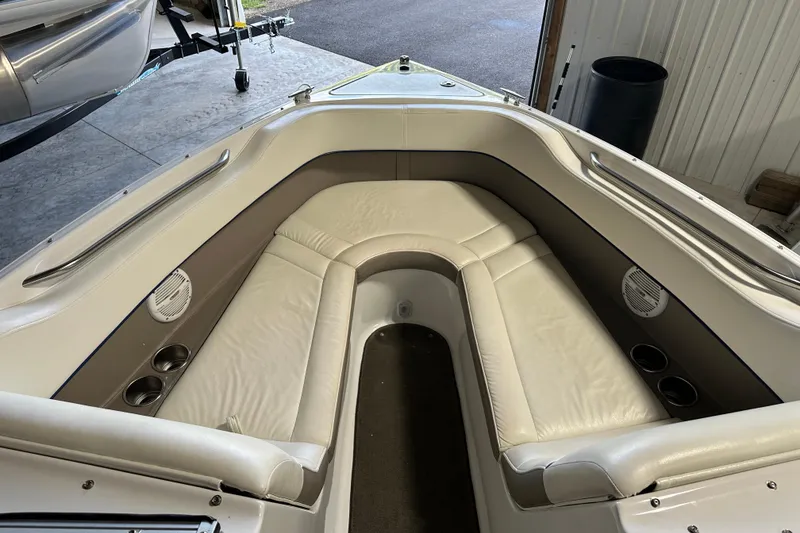 Slide: The Image of 2006 Cobalt 220 boat interior with white leather seating and cup holders. - 18