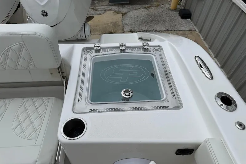 Slide: The Image of 2026 Sea Pro 322 Offshore boat interior with seating and storage compartment. - 17