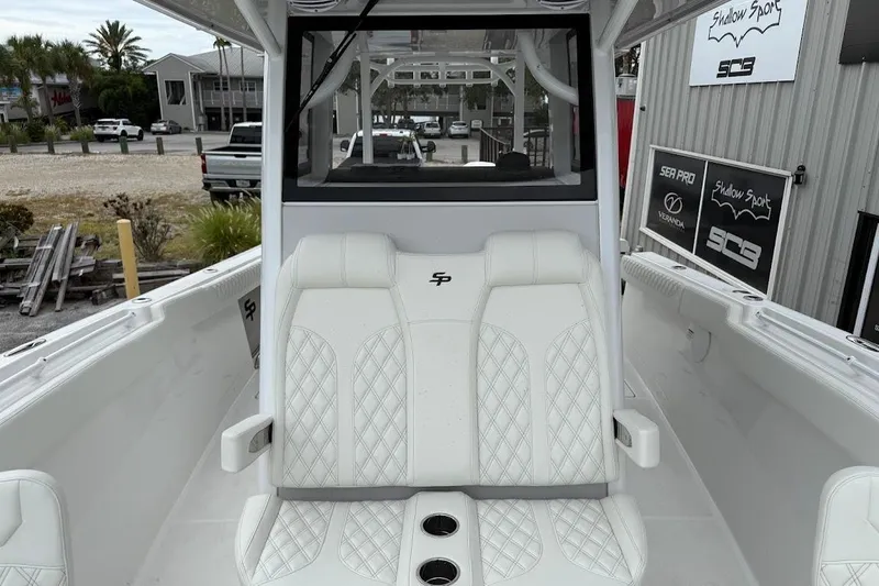 Slide: The Image of 2026 Sea Pro 322 Offshore boat interior with white seating and cup holders. - 24
