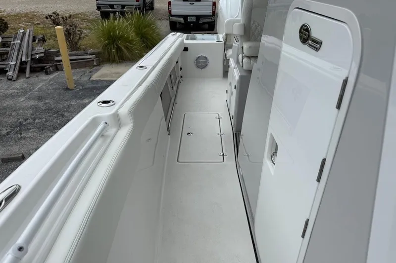 Slide: The Image of 2026 Sea Pro 322 Offshore boat interior, featuring sleek white design and spacious walkway. - 25