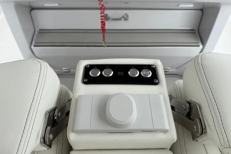 Slide: The Image of 2026 Sea Pro 322 Offshore boat seat controls with white leather upholstery. - 31