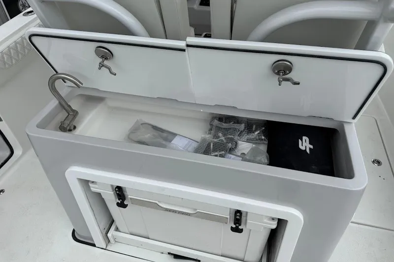 Slide: The Image of 2026 Sea Pro 322 Offshore boat sink and storage area with accessories. - 32