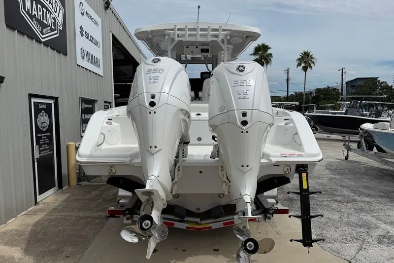 Slide: The Image of 2026 Sea Pro 322 Offshore boat with dual 350 V6 engines at a marine dealership. - 8