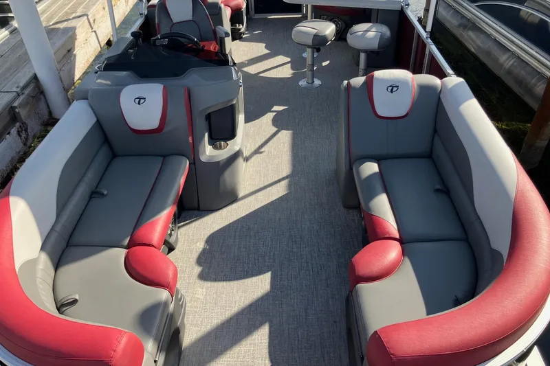The Image of 2023 Tahoe Pontoon Cascade Platinum Versatile Rear Bench 23' interior with red and gray seating. - 1