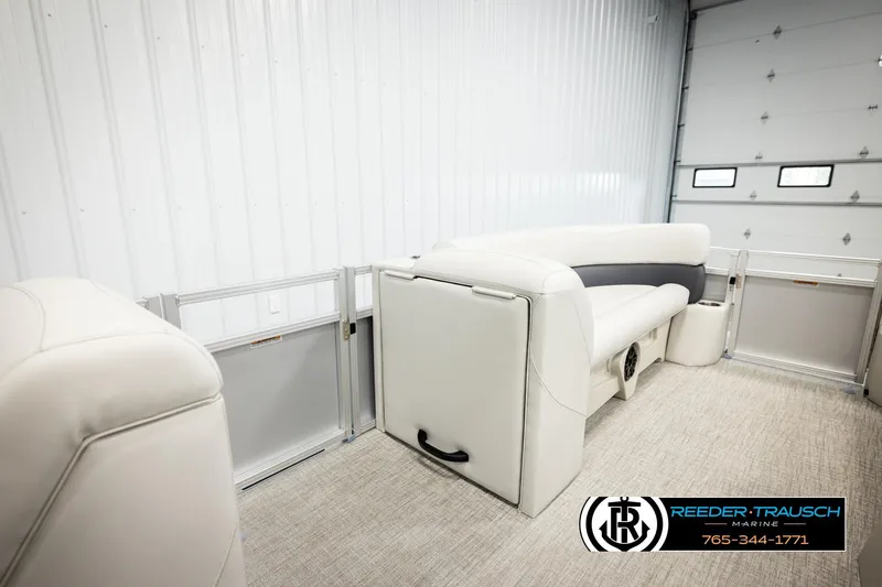 Slide: The Image of 2026 Avalon VLS QL boat interior with white seating in a garage setting. - 26