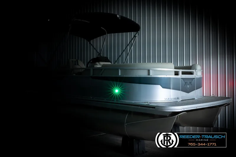 Slide: The Image of 2026 Avalon VLS QL pontoon boat in dimly lit showroom, showcasing sleek design. - 4