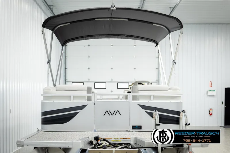 Slide: The Image of 2026 Avalon VLS QL pontoon boat in showroom, featuring sleek design and canopy. - 7