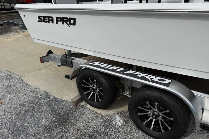 Slide: The Image of 2026 Sea Pro 230 Bay boat on trailer, featuring sleek design and modern wheels. - 10