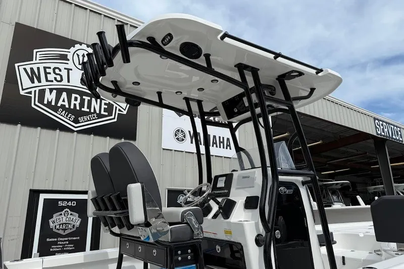 Slide: The Image of 2026 Sea Pro 230 Bay boat at West Coast Marine dealership, featuring modern console and seating. - 11