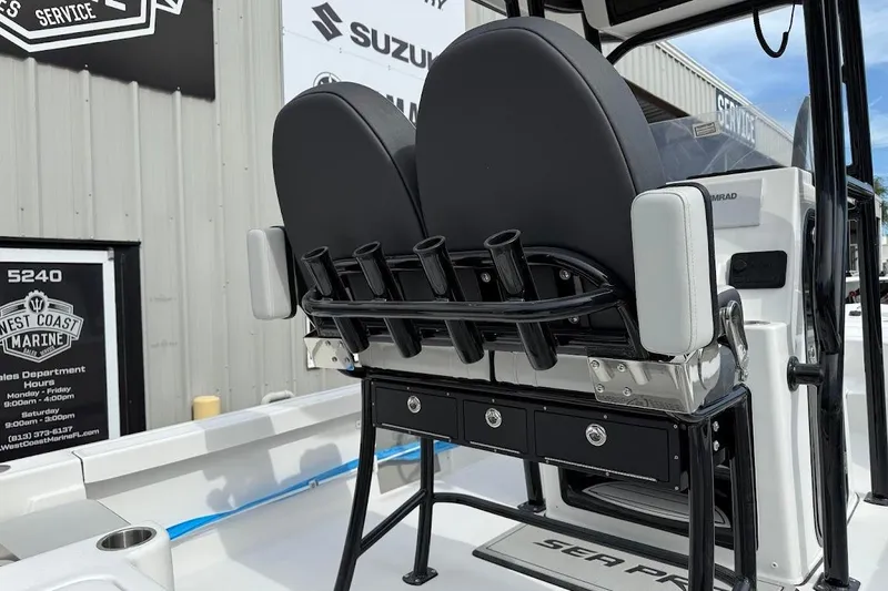 Slide: The Image of 2026 Sea Pro 230 Bay boat interior with rod holders and storage compartments. - 12