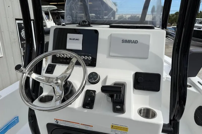 Slide: The Image of 2026 Sea Pro 230 Bay boat console with Simrad and Suzuki controls. - 16
