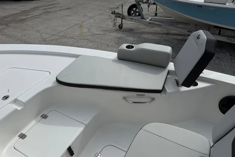 Slide: The Image of 2026 Sea Pro 230 Bay boat interior with cushioned seating and storage compartments. - 23